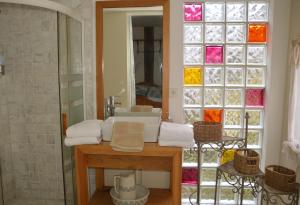 a bathroom with a sink and a glass window at Séminaire Comme à la Maison - cosy, écossais & productif en Sologne in Aubigny-sur-Nère +24 photos