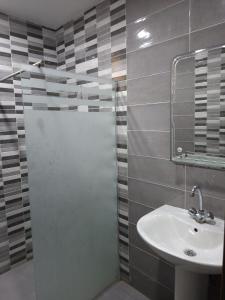 a bathroom with a sink and a shower with a mirror at Appartements Mimosa in Tefeschoun +23 photos