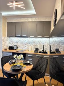 a kitchen with a table and two chairs and a kitchen with a counter at Skyline Panorama in Vrnjačka Banja