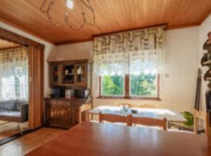 a kitchen with a table and a sink and a window at Holiday House Briški in Delnice +32 photos