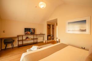 a hotel room with a bed and a television at Saska Boutique Hotel in Cusco