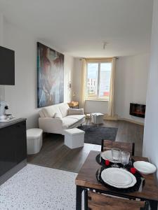 a living room with a couch and a table at Petit appartement charmant in Lille