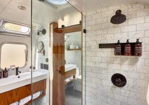 a bathroom with a shower and a sink at AutoCamp Sonoma in Guerneville +55 photos