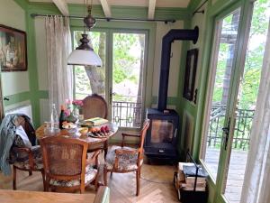 a living room with a table and a wood stove at Baumhaus auf dem Kellerberg in Fischach +14 photos
