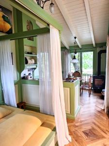 a bedroom with a bed and a living room at Baumhaus auf dem Kellerberg in Fischach