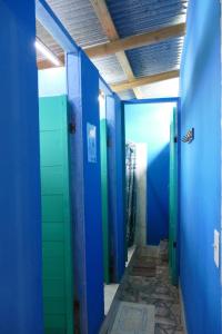 a bathroom with blue walls and green tiles at The Bocas Corner in Bocas Town +35 photos