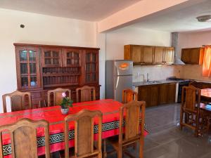 a kitchen with a table and a refrigerator at Casa cairo in Ostende