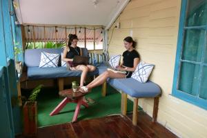 two women sitting on chairs in a room with their laptops at The Bocas Corner in Bocas Town