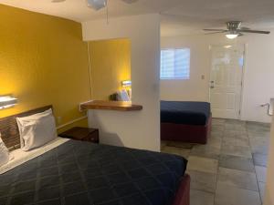 a bedroom with two beds and a yellow wall at Condomino Maripina in Arena +15 photos