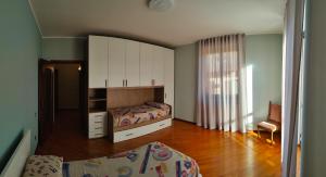 a bedroom with two beds and a large cabinet at Ca Martin in Tresivio