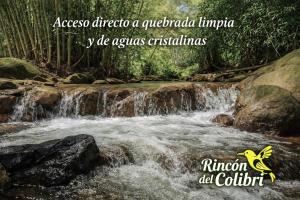 a waterfall in the middle of a river at Rincón del Colibrí in La Vega