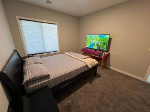 a small bedroom with a bed and a window at Pond view Walkout in Airdrie