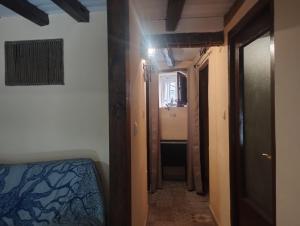 a hallway of a room with a bed and a hallway at Winahost Casita Sierra de Madrid in Las Herreras