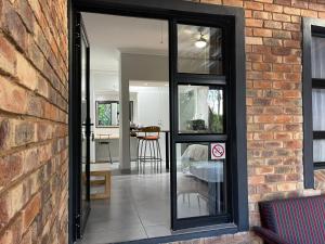 a glass door leading to a room with a dining room at Luigi's Place in Pretoria