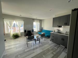 a kitchen and living room with a table and chairs at Pond view Walkout in Airdrie +2 photos