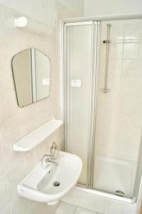 a bathroom with a sink and a shower at Stichting InnEssence Stokershorst in Nederweert-Eind +15 photos