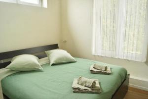 a bedroom with a bed with two towels on it at Stichting InnEssence Stokershorst in Nederweert-Eind