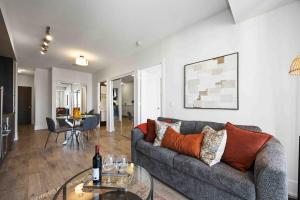 a living room with a couch and a table at Condo by CN Tower & Rogers Centre in Toronto