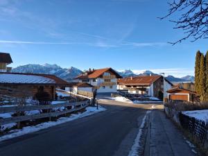 a street in a village with snow covered buildings at Haus der Hoffnung in Füssen