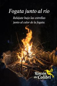 a bonfire in the night with the text fociaria tatio nric at Rincón del Colibrí in La Vega