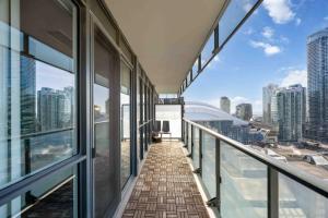 an empty balcony with views of the city at Condo by CN Tower & Rogers Centre in Toronto