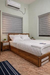 a bedroom with a large bed and a air conditioner at Golden Breeze Bekal in Bedadka