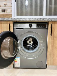 a washing machine in a kitchen next to a counter at sahara house in Laayoune