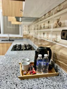 a tray with water bottles on a counter in a kitchen at sahara house in Laayoune
