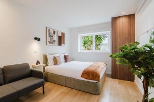 a bedroom with a bed and a couch at Póvoa Studios by Pomerania in Póvoa de Varzim