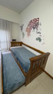 a bed in a room with a sign on the wall at Mimi’s dream Luján in Luján