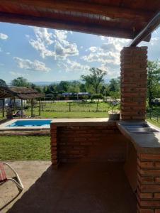 a brick patio with a view of a pool at Cabaña gio in Potrero de Garay