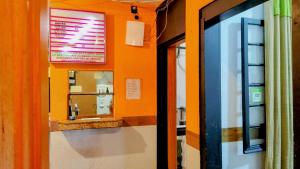 an orange room with a window and a mirror at Casarão da Sé in São Paulo +14 photos