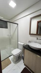 a bathroom with a shower and a toilet and a sink at Apartamento em Pomerode - 203 in Pomerode