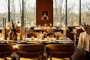 a restaurant with tables and chairs and large windows at Claramount Club in Picton