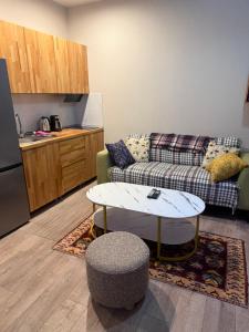 a living room with a couch and a table at Nino's Home in Bakuriani
