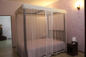 a bed with a canopy in a room at GalleRetreat in Galle