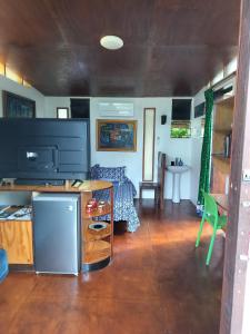 a living room with a large television and a table at Vaianae Sands in Haapiti