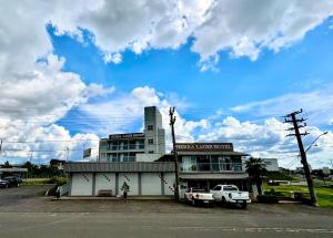 a building with a truck parked in front of it at Sierra Lages Hotel in Lages