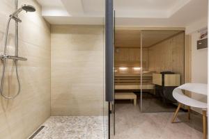 a bathroom with a shower and a sink at Sylter Inselglück in Wenningstedt +36 photos