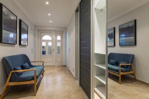 a hallway with two chairs and a mirror at Sylter Inselglück in Wenningstedt