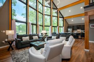 a living room with white furniture and large windows at Sunset On The Greens by Railey Vacations in McHenry