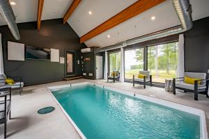 a swimming pool in a house with a large window at Sunset On The Greens by Railey Vacations in McHenry