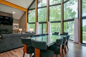 a living room with a glass table and chairs at Sunset On The Greens by Railey Vacations in McHenry +82 photos
