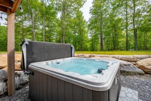 a hot tub in the middle of a yard with trees at Sunset On The Greens by Railey Vacations in McHenry