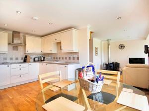 a kitchen with a glass table and chairs in a kitchen at 2 Bed in Ardross oc-ca384 in Stittenham +13 photos