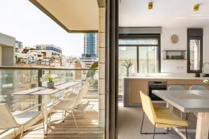 a kitchen and dining room with a view of the city at Luxury Beachside 3BR with Balcony in Tel Aviv