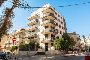 a tall white building on a city street at Luxury Beachside 3BR with Balcony in Tel Aviv