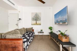 a living room with a couch and a table at Luxury Beachside 3BR with Balcony in Tel Aviv