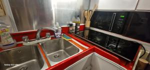 a kitchen with a sink and a microwave at Ma Belle Lana, Chantereyne Marina in Cherbourg en Cotentin +30 photos