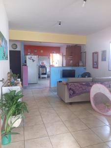 a living room with a bed and a kitchen at Sol guest house in Pipa
